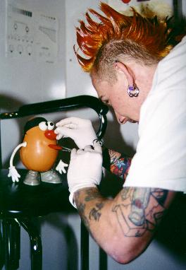 Completely off his rocker, he decides to get his tongue pierced as well!