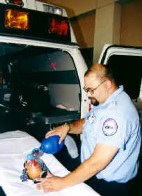 An EMS technician works feverishly to keep Spud alive