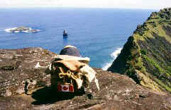 Spud looks out to the islet of Motu Nui from the crater rim of Rano Kau